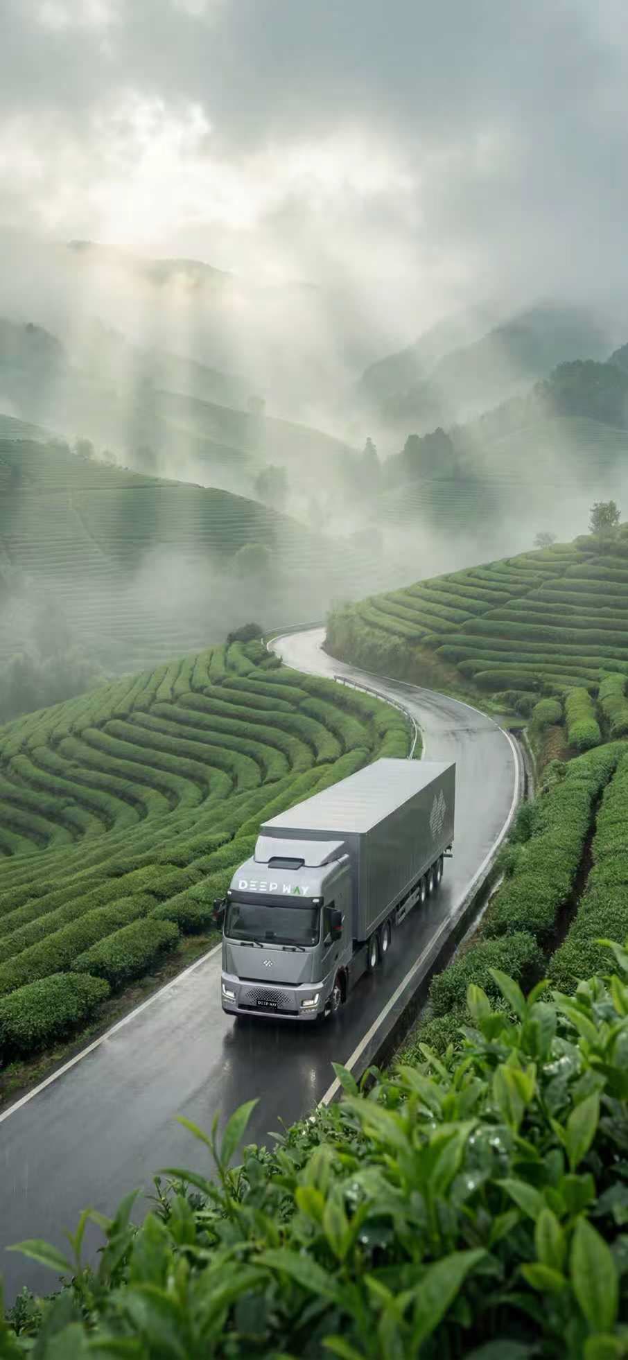 A Deepway Star prime mover on a wet road winding through terraced tea fields